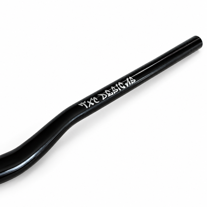 Glossy black TXC Vanta Series 31.8 mm direct-mount e-moto handlebar, close-up of the TXC Designs branding.