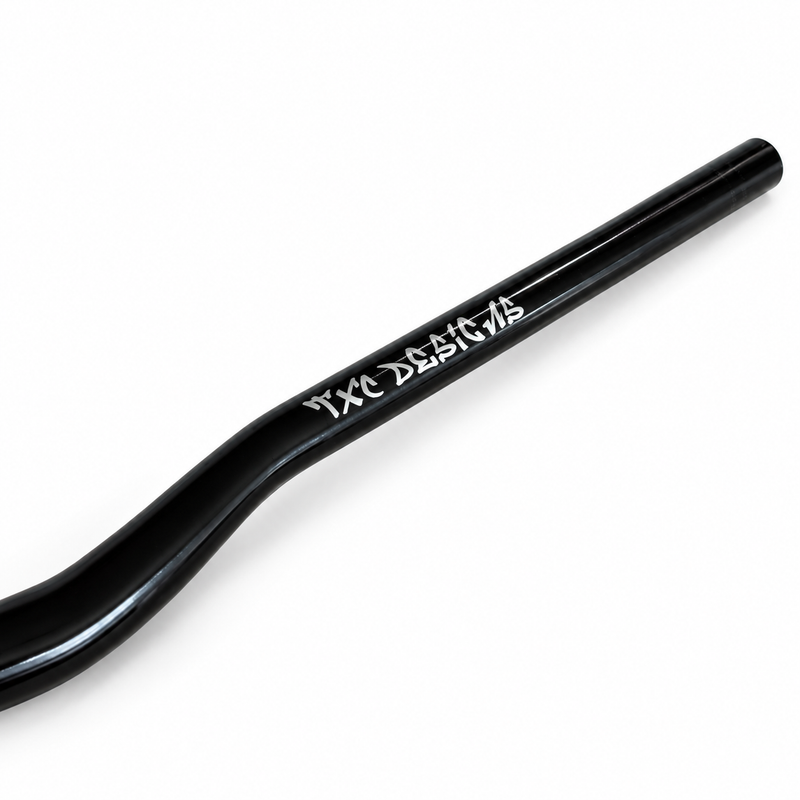 Glossy black TXC Vanta Series 31.8 mm direct-mount e-moto handlebar, close-up of the TXC Designs branding.